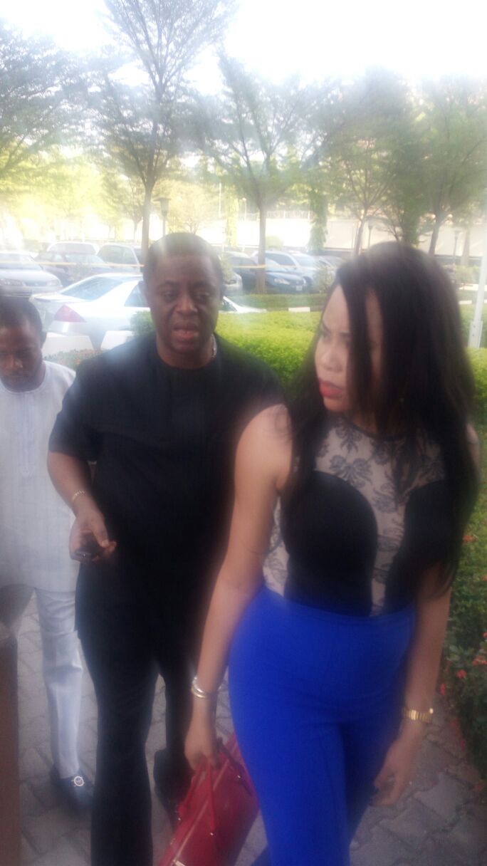 Chief Fani-Kayode (in black) walks behind his wife, Precious Chikwendu at the premises of the federal high court in Abuja