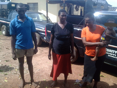 The suspects with the rescued baby (Photo: Vanguard)