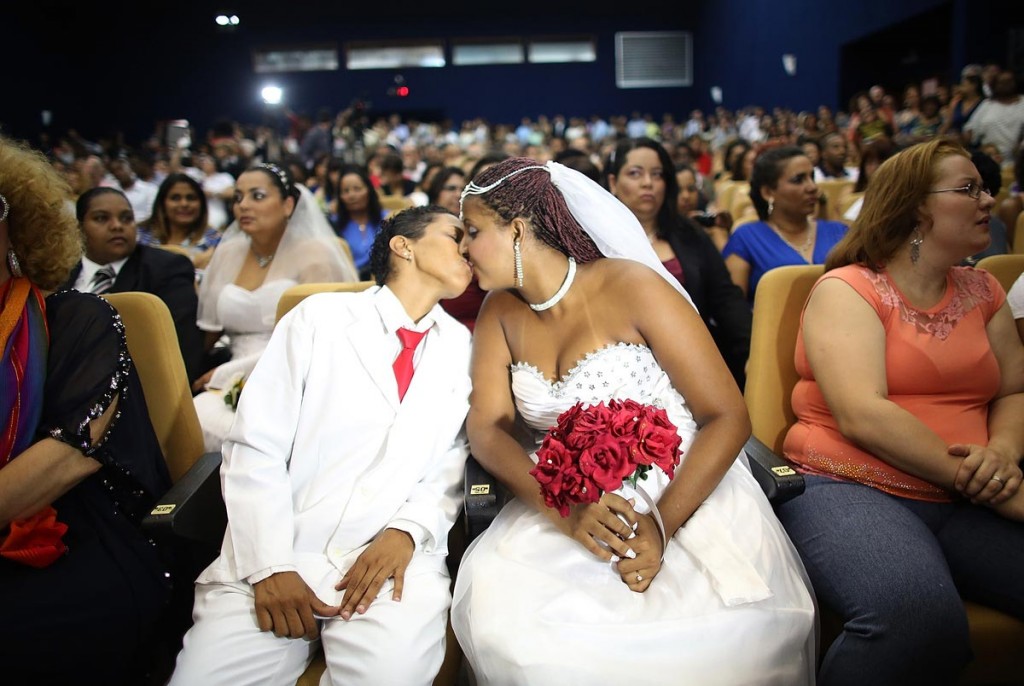 Joyce and Gabrieli (R) kiss before marrying at what was billed as the world's largest communal gay wedding on December 8, 2013 in Rio de Janeiro, Brazil. 130 couples were married at the event which was held at the Court of Justice in downtown Rio. In May, Brazil became the third country in Latin America to effectively approve same-sex marriage via a court ruling, but a final law has yet to be passed. (Photo by Mario Tama/Getty Images)