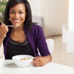Attractive African American eating breakfast