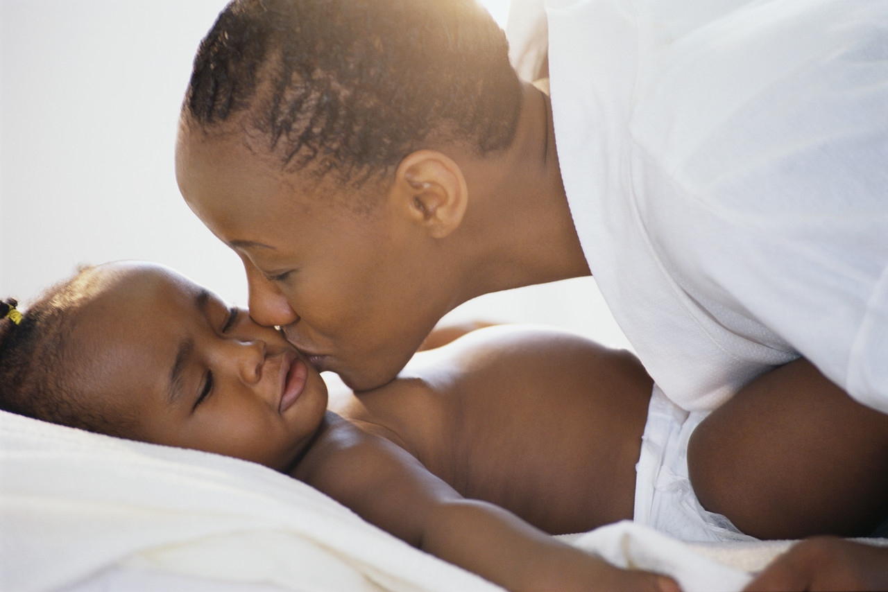 Mother Kissing Toddler's Cheek --- Image by © Royalty-Free/Corbis