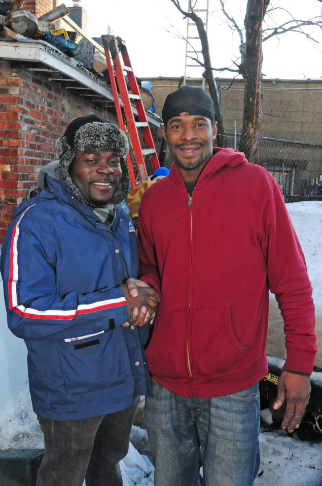 Hero mailman Jermaine Shirley shakes hands with the twins’ father, Everdean Codner.