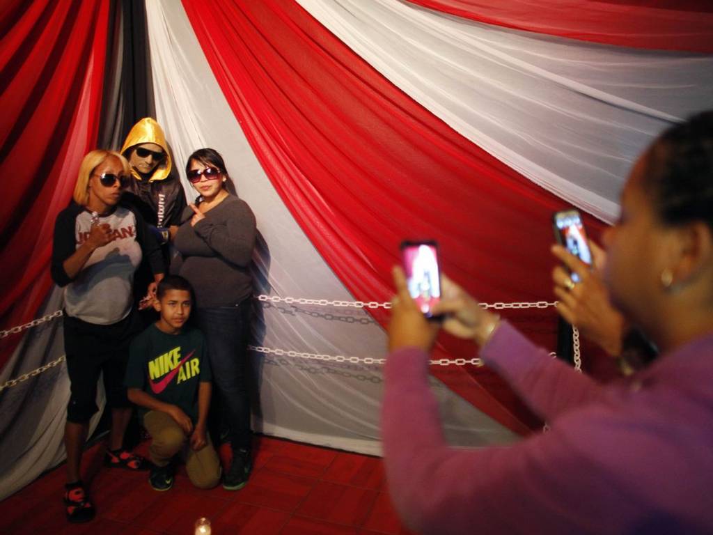 Family pose with Rivera Lidianette Carmona, behind right, the wife of the late boxer Christopher Rivera, stands with Rivera's mother Celines Amaro, left, and Rivera's son Julio Christopher, as they pose for photos taken by fans with his body AP (Photo Credit: AP)