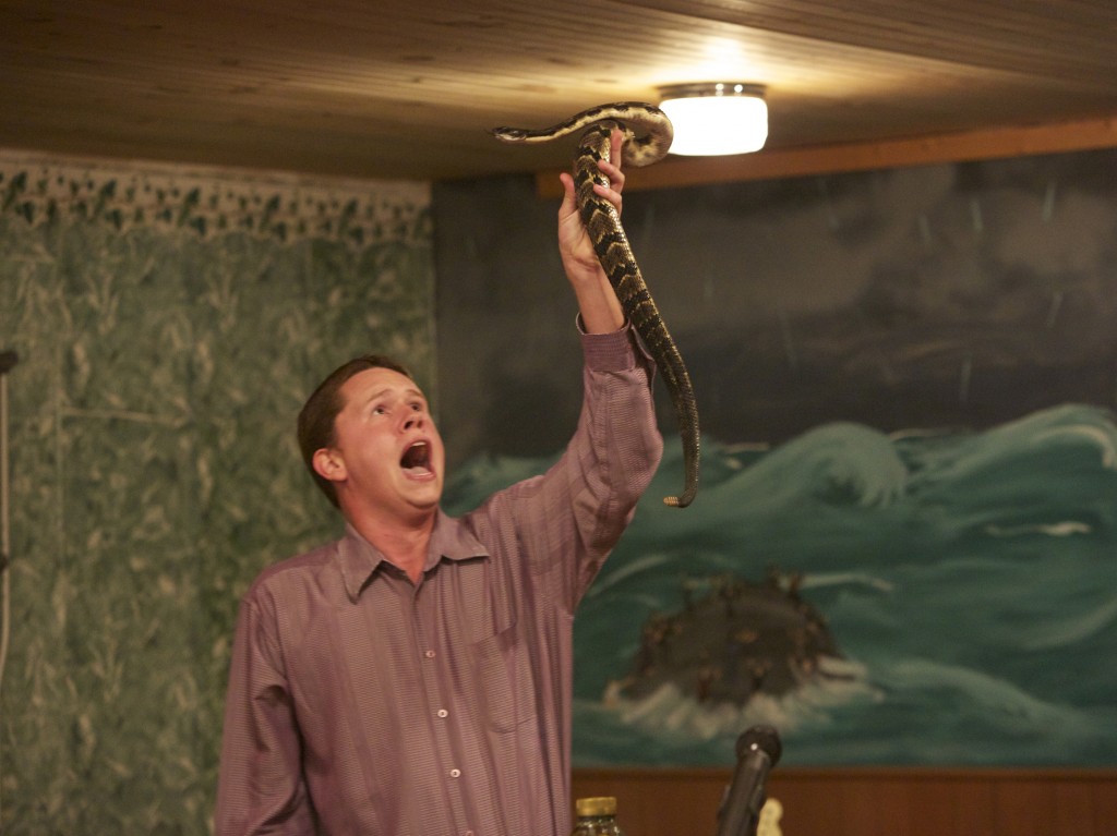 Andrew Hamblin preaches while holding a snake above his head, LaFollette, Tenn.