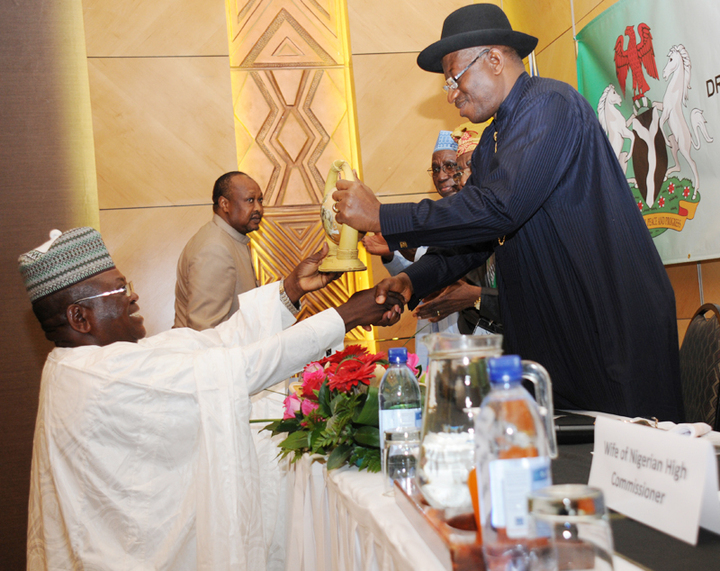PRESIDENT GOODLUCK JONATHAN RECEIVING A SOUVENIR FROM THE PRESIDENT, NIGERIAN COMMUNITY IN NAMIBIA, MR BUBA MADUGU, AT A MEETING OF PRESIDENT JONATHAN WITH NIGERIANS IN NAMIBIA ON THURSDAY.