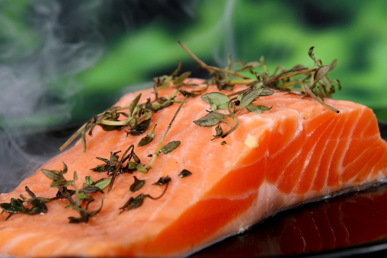 Summer food, rose colored fish steak in a wine marinade macro closeup