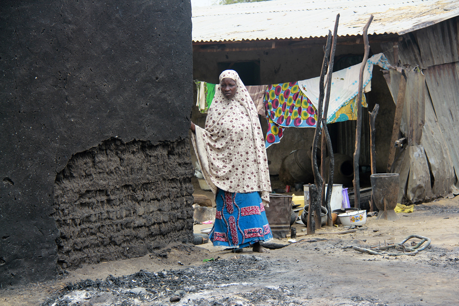 Borno Boko Haram Featured A woman stands next to a burnt house in the aftermath of what Nigerian authorities said was heavy fighting between security forces and Islamist militants in Baga