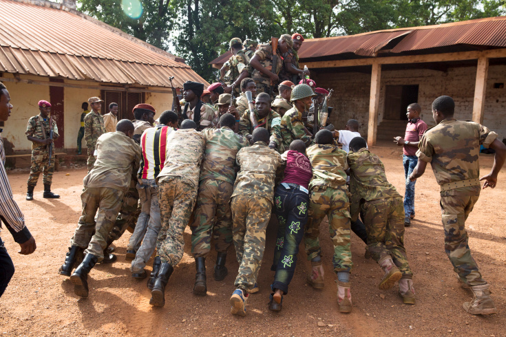 Bambari. Some ex Seleka fighters are pushing a pick up that run out of battery, in a Seleka base in Bamabari. It carries about 15 fighters, travelling to Grimari where Antibalakas are trying to attack the city that is the gate to the Ouaka region that is still controlled by ex Seleka. Ex-seleka general Ali Mahamat Darrassa is relatively appreciated for having fought and expelled others Seleka who were installing terror among the city communities. Sangaris troops trust him, thinking he is the only way to keep Ouaka region out of violence. (Photo Credit: William Daniels/Panos)