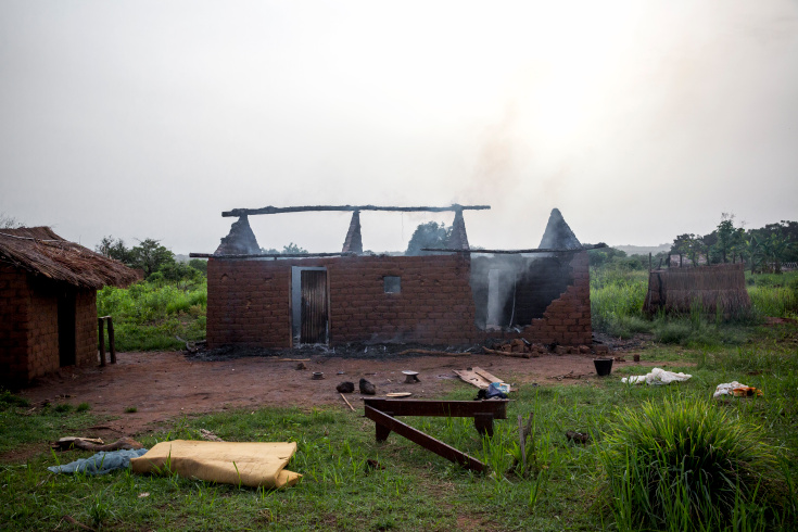 Gulinga, 5 km of Grimari. An house is still burning is the village of Gulinga where Seleka fighters just killed 3 christians (2 men and one woman) and Kidnaped another one, accusing them of being Antibalakas. The woman was killed as a "collateral damage". Grimari is being attacked by Antibalakas for 2 days as it is the gate to the Ouaka region that is still controlled by ex Seleka fighters whose general Ali Mahamat Darrassa is relatively appreciated by both muslims and christians for having fought and expelled others Seleka who were installing terror among the city communities. Sangaris troops trust him, thinking he is the only way to keep Ouaka region out of violence. (Photo Credit: William Daniels/Panos)
