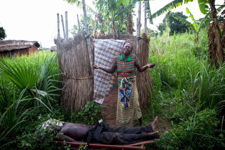 Gulinga, 5 km of Grimari. Relatives cry the death of 2 men and one woman slaughtered just before by ex Seleka fighters in the village of Gulinga, accusing them of being Antibalakas. The woman was killed as a "collateral damage" according to a Seleka colonel who admitted the killing. Grimari is being attacked by Antibalakas for 2 days as it is the gate to the Ouaka region that is still controlled by Seleka fighters whose general Mahamat Darrassa is relatively appreciated bu both muslims and christians for having fought and pushed away others Seleka who were installing terror among the city communities. Sangaris troops trust him, thinking he is the only way to keep Ouaka region out of violence. (Photo Credit: William Daniels/Panos)