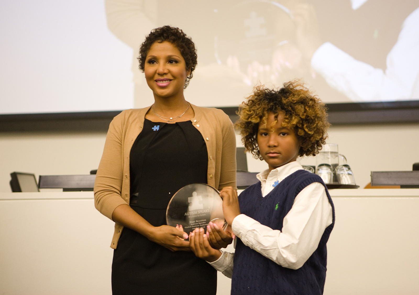 Toni Braxton receives an award from Autism Speaks with her son