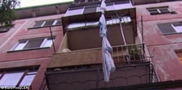 A 29-year-old woman is said to have escaped her captor, who kept her and three other women in his flat, by using knotted sheets to climb to safety