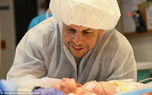 Father: Bill Thistlethwaite seems to look lovingly at his new daughter (Photo Credit: Akron Children's Hospital)