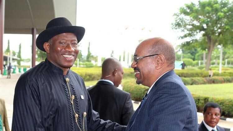 President of Nigeria Goodluck Jonathan, left, and Sudanese President Omar al-Bashir right, shake hands before an African Union summit in Abuja, Nigeria Monday, July 15, 2013 (Photo Credit: AP/Sunday Aghaeze)
