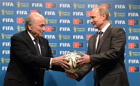 In this file photo taken on Sunday, July 13, 2014, FIFA President Sepp Blatter, left, and Russian President Vladimir Putin hold a soccer ball during the official ceremony of handover to Russia as the 2018 World Cup hosts, after the World Cup final soccer match between Germany and Argentina at the Maracana Stadium in Rio de Janeiro, Brazil. (AP Photo/RIA-Novosti, Alexei Nikolsky, Presidential Press Service, File)