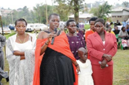 Gloria Tumwijuke (with microphone), Alice Ngonzi Isoke (folding hands in red dress), Diana Alinaitwe (behind Alice), Mrs Isoke (Alice’s mother), an unidentified health worker(on Gloria’s right) and a granddaughter to Mrs Isoke – all Ebola survivors narrating their ordeal at Kagaadi Hospital during the function to officially declare Uganda Ebola free. (Photo Courtesy: WHO)