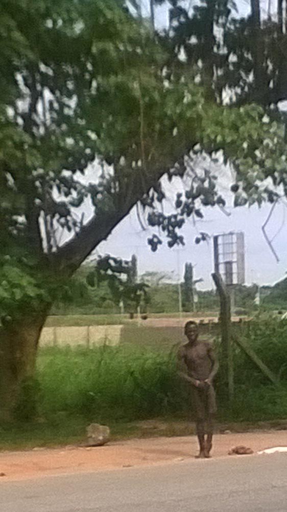 The 22-year-old Boko Haram suicide bombing suspect captured on surveillance video as he undressed and attempted to wear his bomb. He was arrested at the Lagos Airport August 19, 2014 (Photo Credit: The Trent/BAB)