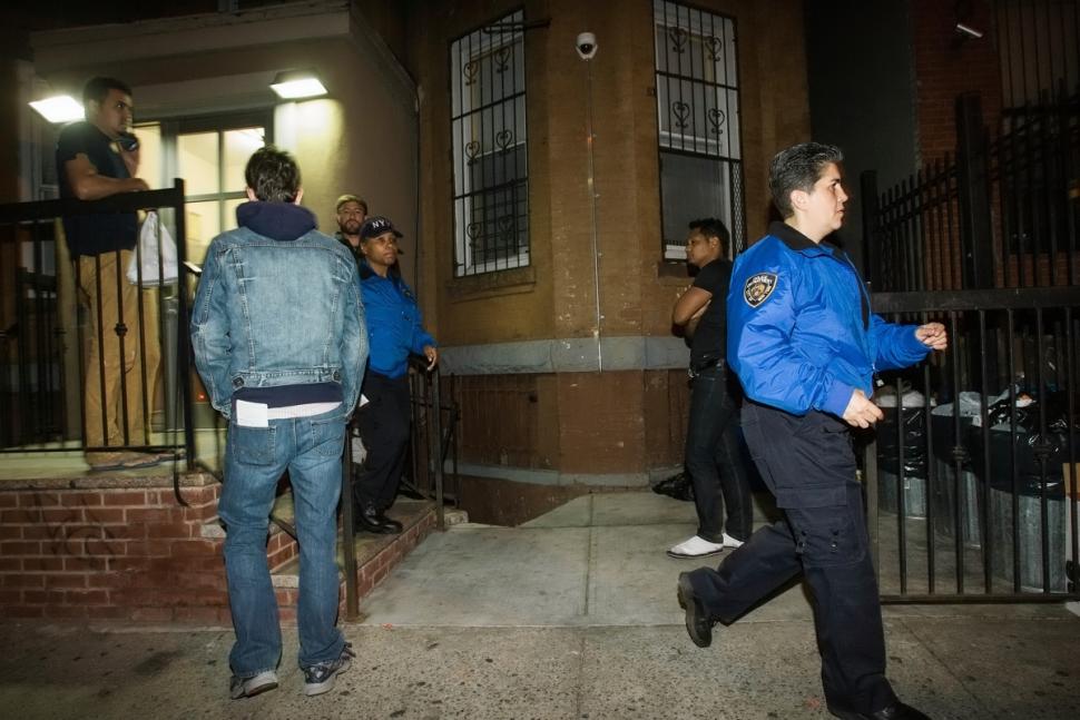 Two officers leaving the Cooper St. building where the brutal beatings occurred. (Photo Credit: New York Daily News)