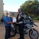 Receiving the Iron Butt Association Membership from President, Hendrik