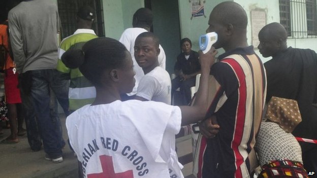 Liberian Red Cross Volunteer Checking Temperature Rates Of Voters Before Voting (Photo Credit: BBC)
