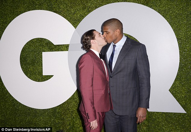 NFL player Michael Sam kisses his boyfriend Vito Cammisano after being named GQ Man of the Year 2014 in West Hollywood on Thursday, December 4, 2014. (Photo Credit:AP)