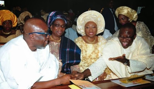 Ekiti State incumbent governor, Ayo Fayose and former governor, Kayode Fayemi exchange pleasantries at birthday service of former governor, Segun Oni on Sunday, december 7, 2014 in Ekiti (Photo Credit: Punch)