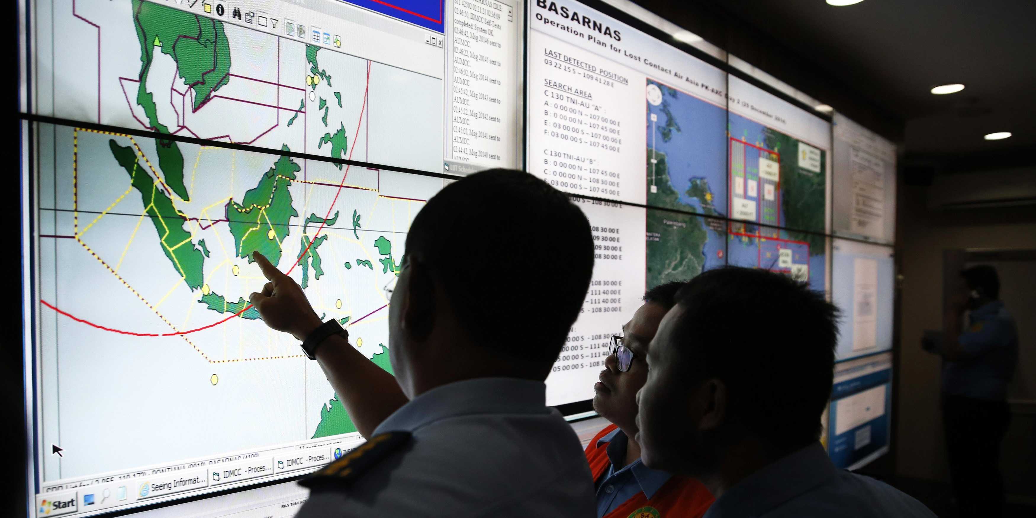 Military and rescue authorities monitoring progress in the search for AirAsia Flight QZ8501 in the Mission Control Center inside the National Search and Rescue Agency in Jakarta on Monday. (Photo Credit: REUTERS/Darren Whiteside)