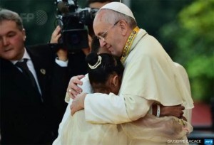 Pope Francis embraces a girl during a meeting with young people at Manila university Philippines on Sunday, January 18, 2015. (Photo credit: Reuters)