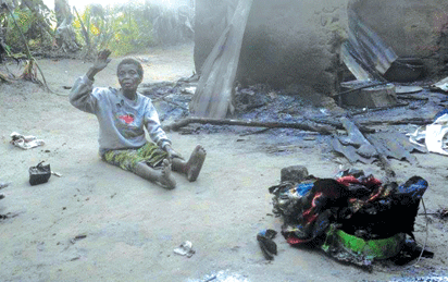 90-year-old woman and the remains of her house and property following an inter-communal clash in Akwa Ibom. (Photo Credit: Niger Delta Voice)