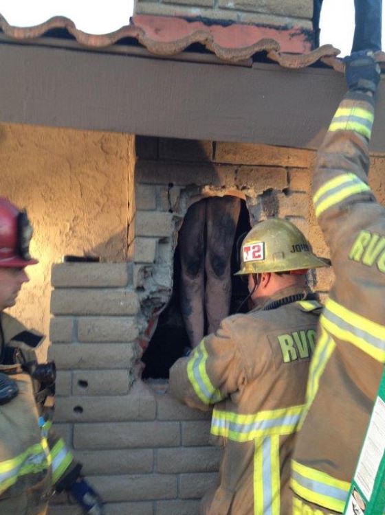 Firefighters broke into the fire place to rescue the woman (Photo Credit: Cal Fire Riverside/Twitter)