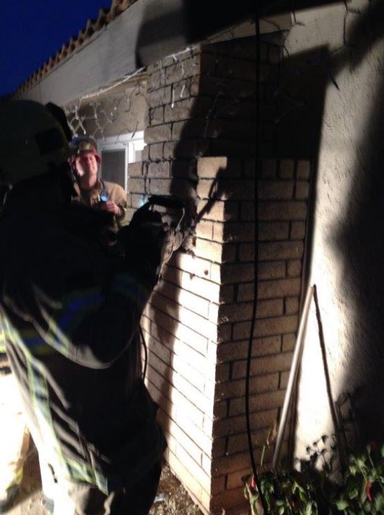 Firefighters broke into the fire place to rescue the woman (Photo Credit: Cal Fire Riverside/Twitter)