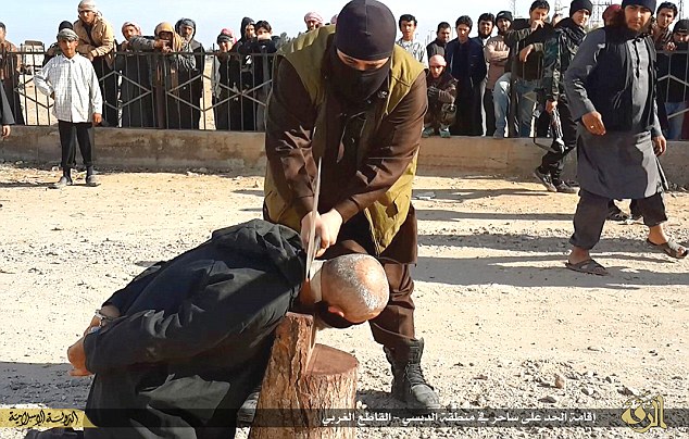 The victim being executed in a rural area named Aldbsa, to the west the city of Raqqa by ISIS militants for alleged witchcraft. (Photo Credit: Mail Online)