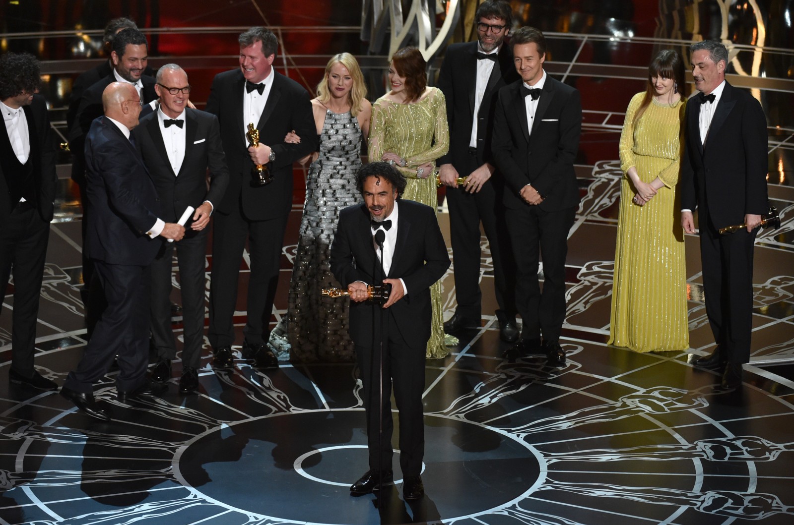 Alejandro G. Inarritu, center, and the cast and crew of ìBirdman or (The Unexpected Virtue of Ignorance)î accept the award for the best picture at the Oscars on Sunday, Feb. 22, 2015, at the Dolby Theatre in Los Angeles. (Photo Credit: John Shearer/Invision/AP)