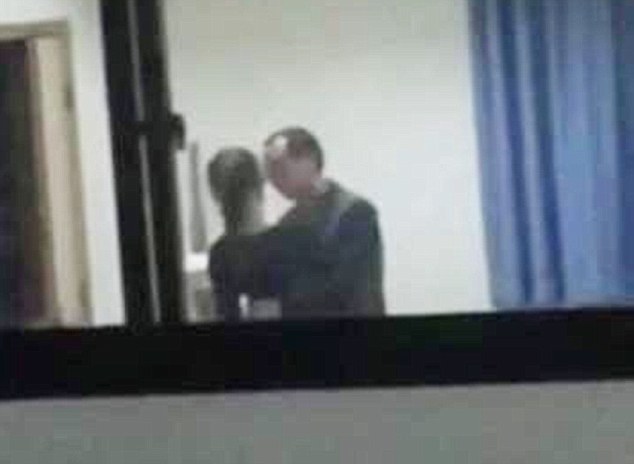 Pervy Xu Ko, 40, was caught molesting and kissing a 16-year-old student in his office at a school in the Yubei District of Chongqing, China. (Photo Credit: Daily Mail)