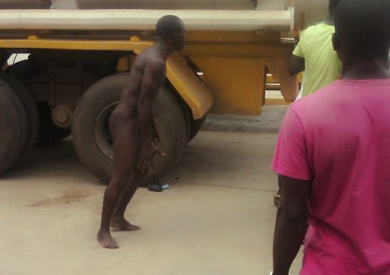 Unidentified man removed his clothes in protest after he was unable to buy fuel at Petrocam petrol station in Igando, a suburb in Lagos state. 