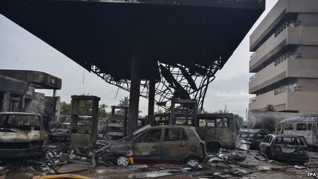 Fuel from the petrol station was spread by flood waters on Wednesday, June 3, 2015 and then ignited and killed some persons taking solace therein. (Photo Credit: EPA)