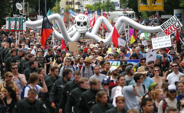Demonstrators march down a street in Garmisch-Partenkirchen, Germany, in advance of the Group of 7's two-day summit, where world leaders will discuss climate change, free trade, terrorism and women’s rights, among a host of other economic and social issues. (Photo Credit:Reuters/Hannibal Hanschke)