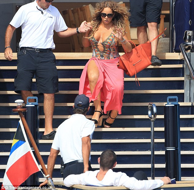 Awkward: James Packer watched on as Mariah Carey took a tumble down the stairs of his super yacht, the Arctic P, on Wednesday in Formentera, Ibiza