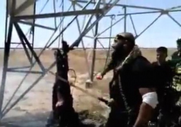 Eye for an eye: New footage from the war-ravaged Iraqi city of Baiji shows an Iraqi fighter known as the 'Angel of Death' slicing the flesh off an ISIS fighter