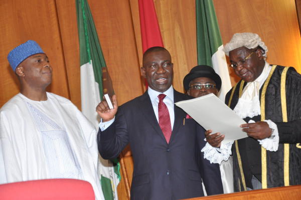 Clerk of the National Assembly, Salisu Maikasuwa (R) swearing-in the Senate President, Bukola Saraki at the Inauguration of the 8th National Assembly in Abuja on Tuesday, 9th of June, 2015 | NAN