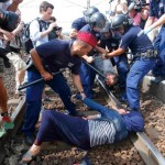 Hungarian-piolicemen-detain-migrants-on-the-tracks-as-they-wanted-to-run-away-at-the-railway-station-in-the-town-of