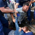 Hungarian-pmolicemen-detain-migrants-on-the-tracks-as-they-wanted-to-run-away-at-the-railway-station-in-the-town-of0