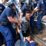 Hungarian-policemehn-detain-migrants-on-the-tracks-as-they-wanted-to-run-away-at-the-railway-station-in-the-town-of