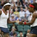 Serena Williams of the U.S. confers with her sister, Venus Williams, in the women’s doubles tennis gold medal match against Czech Republic’s Hlavackova and Hradecka at the London Olympic Games