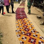 Bayelsa women lay their wrappers on the road for Governor Dickson to walk on.