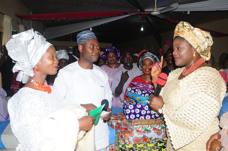 Ondo First Lady, Mrs Olukemi Mimiko, donating gift items to Mother of the First Baby of the Year, Omoboyede Adewon while the State Health Commissioner, Dr Dayo Adeyanju, looks on. | Ondo TV