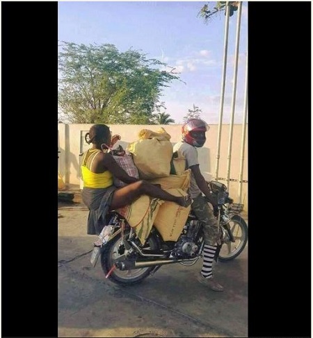 Woman spotted in Lagos State with several bags on top of a commercial motorcycle.