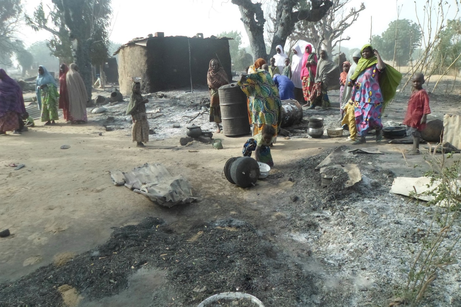 Women and children look at burnt out houses following an attack by Boko Haram in Dalori village 5 kilometers (3 miles) from Maiduguri, Nigeria, Sunday Jan. 31, 2016. | AP/Jossy Ola