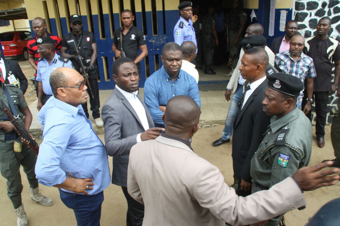 FILE: Dakuku Peterside, DG of NIMASA (centre in blue) pictured at the Mile 1 police station, Port Harcourt on Sunday, May 20, 2016. APC chairman of Rivers State is Davis Ikanya (also in blue on the left end)