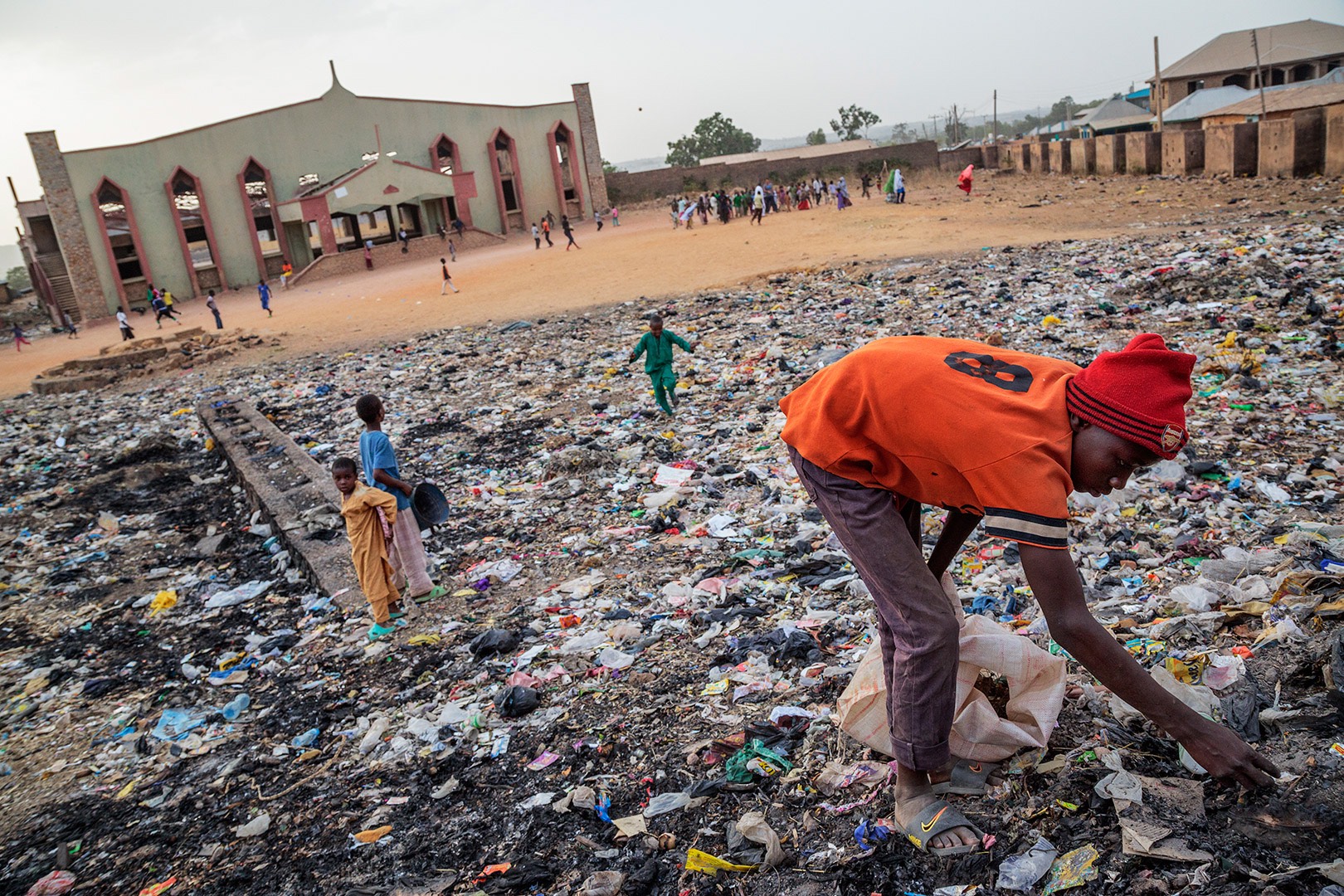 Terrorism as Islamizing Tool: A young Muslim boy picks through garbage in what was once the main Christian church in this community. Due to attacks on the church, the Christians have fled this area. The poverty and lack of development that plagues northern Nigeria and fuels the insurgency is evident in the Muslim section of Angwan Rogo, considered a no go area of Jos, Nigeria on March 25, 2013. | Ed Kashi 